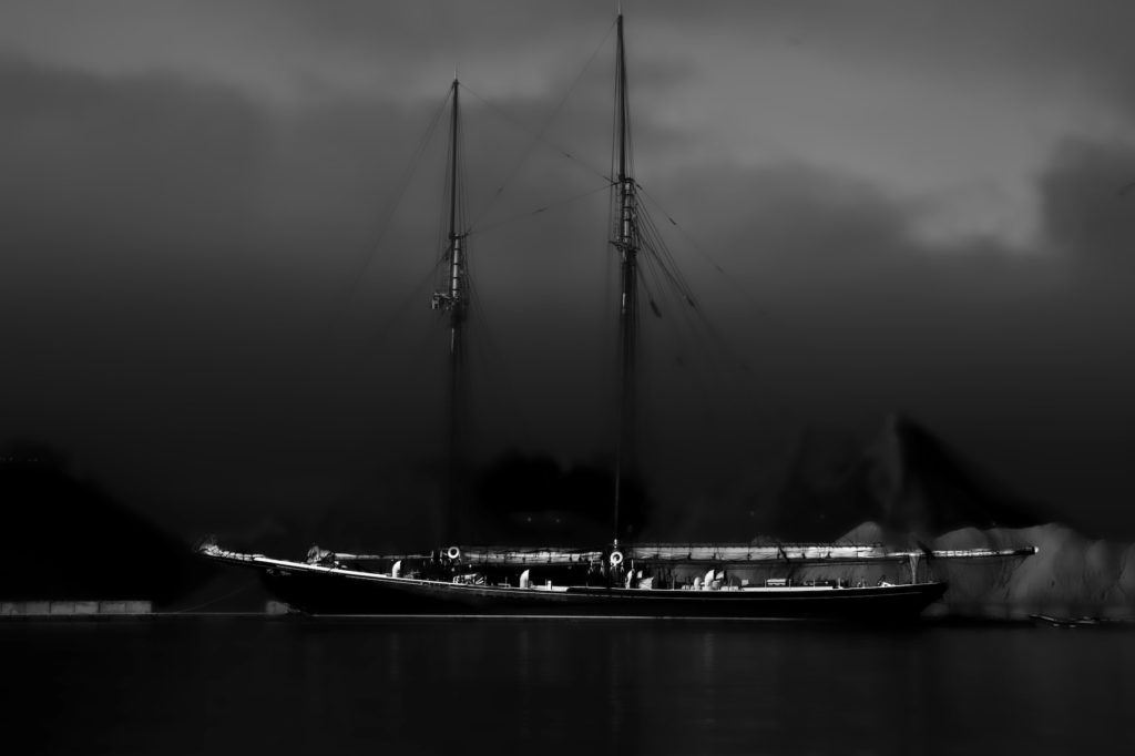 the Bluenose 2 at a dock appearing out from a foggy morning