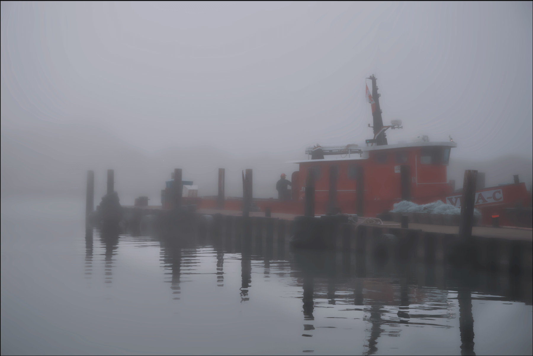 A local area tug boat prepares for it's daily routine. I liked the shot mostly for the reflection in the water which was so divergent from the surrounding fog.