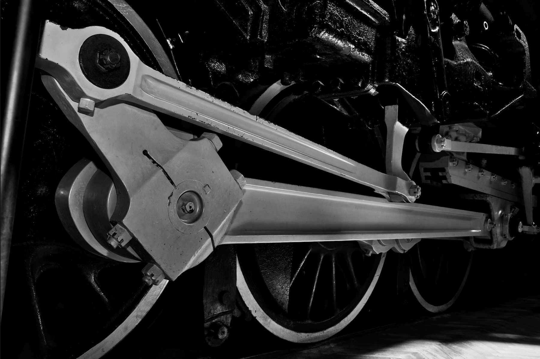 a close up shot f the running gear on an old steam engine