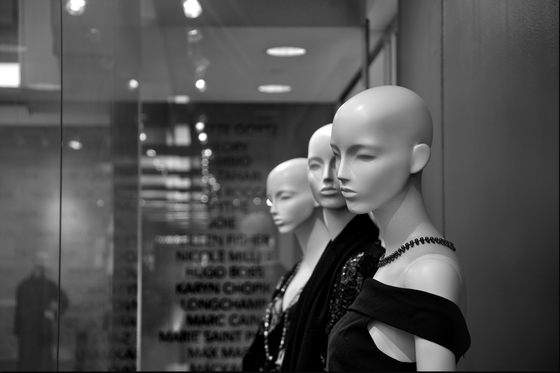 Black & white photograph of three female mannequins