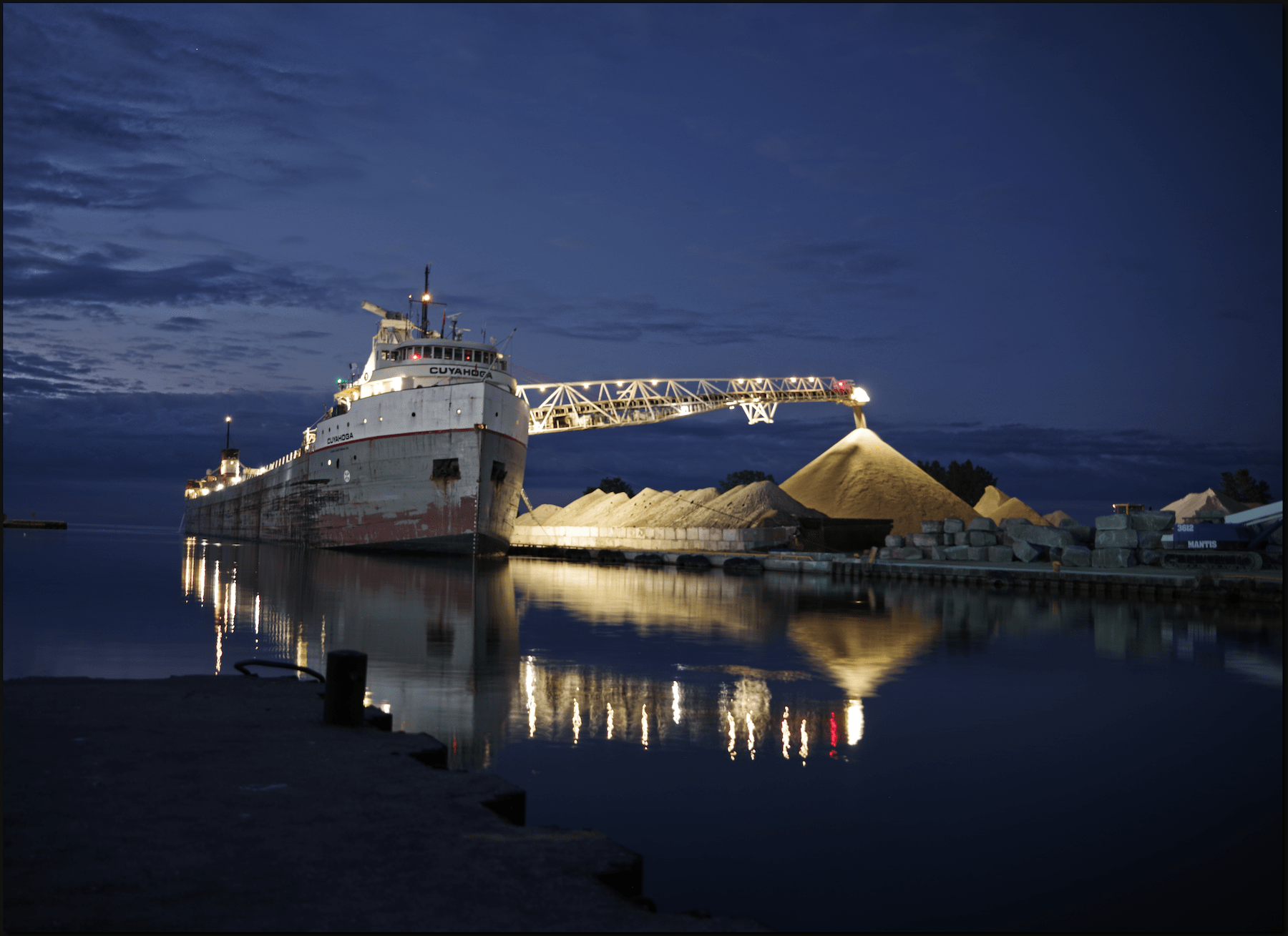 Great lakes freighter discharging aggregate at night in Ontario.
