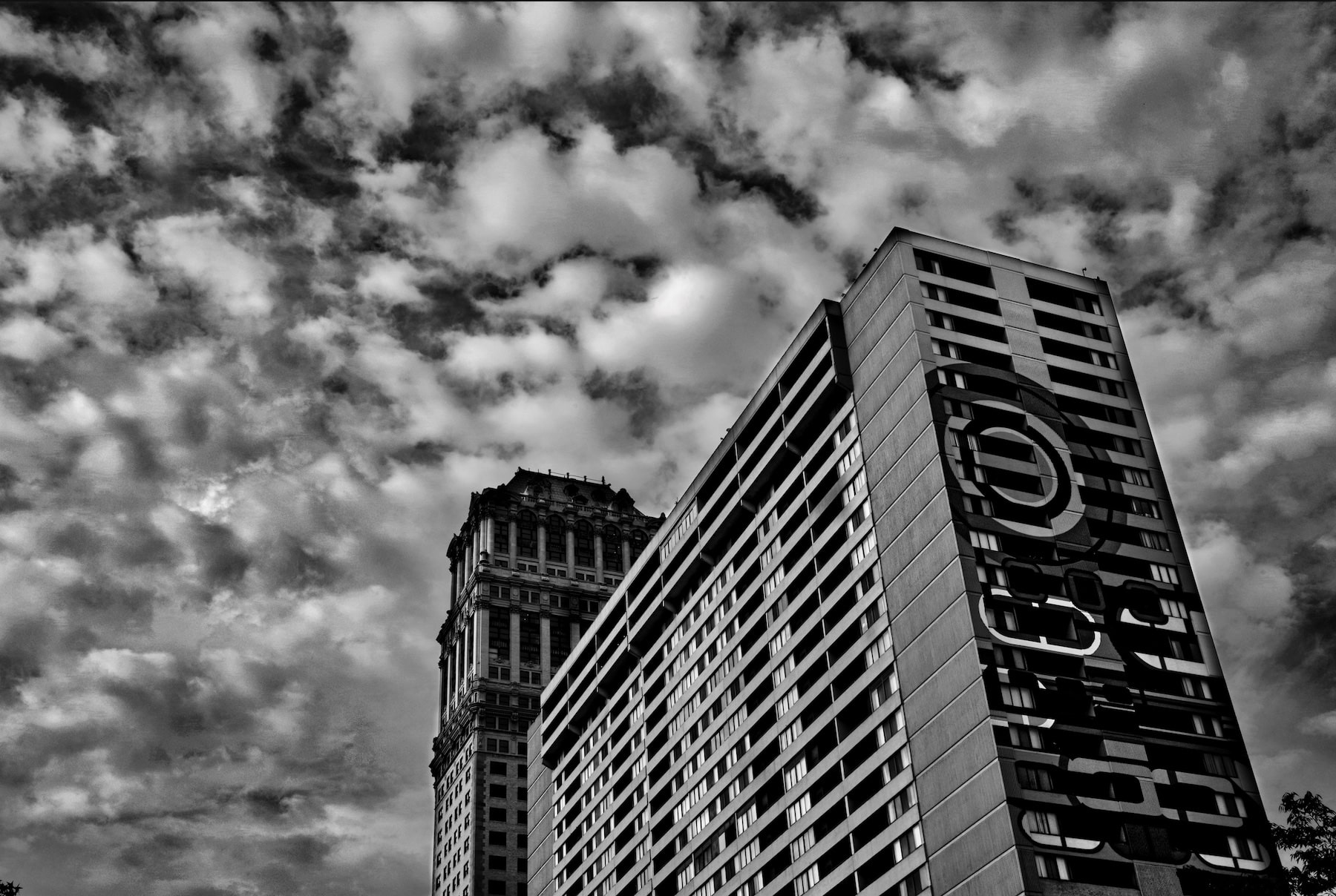 a detroit skyscraper with a wild crazy sky in the background