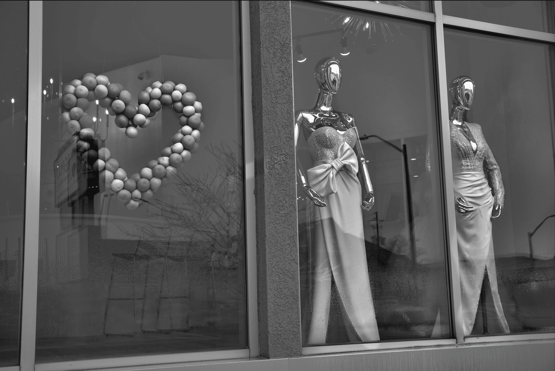 chrome mannequins in a storefront for valentines day