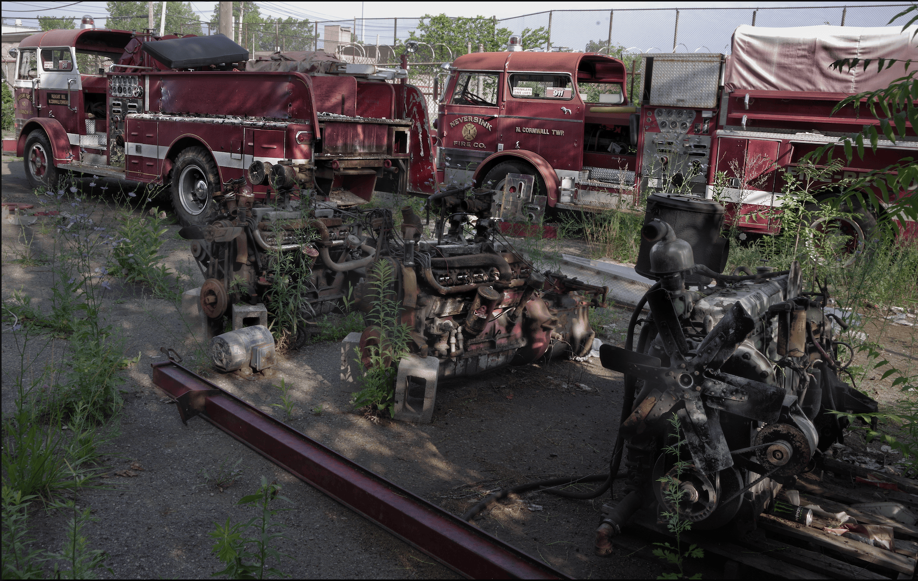 abandoned fire rucks in a Detroit yard