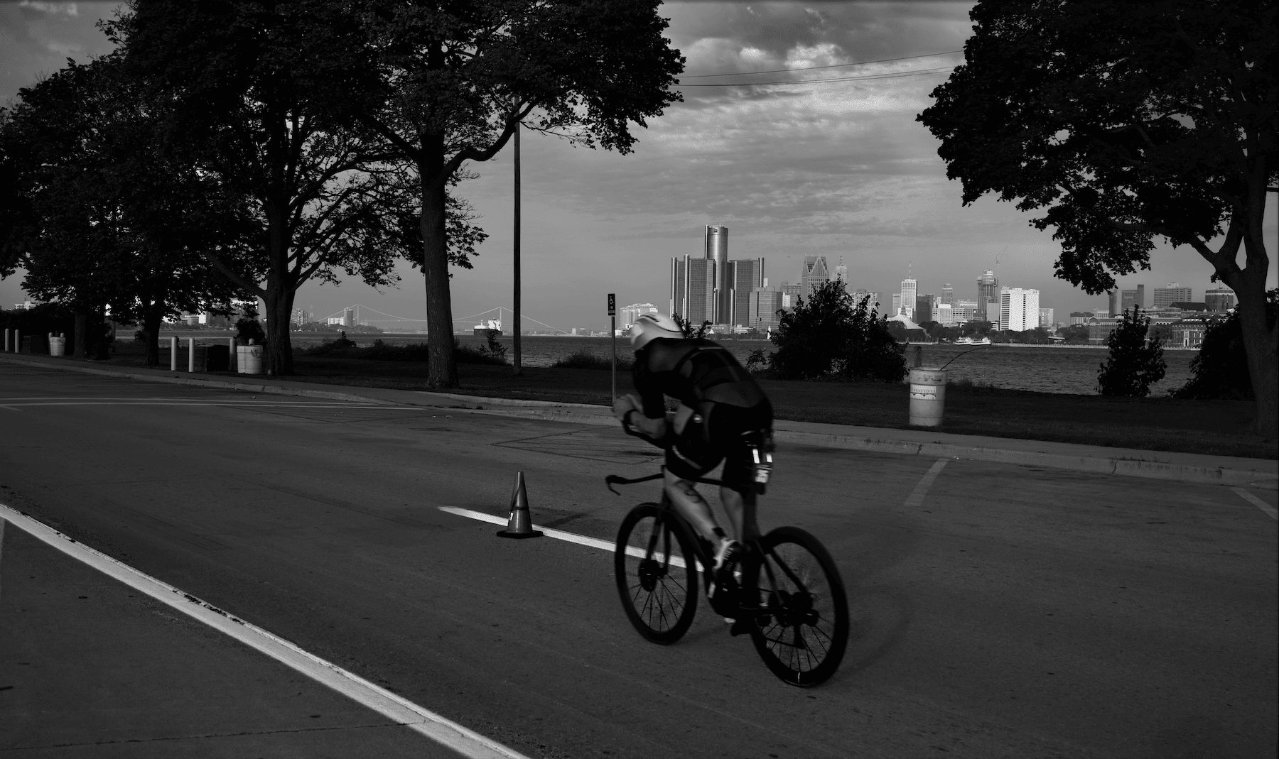 a bicycle racer with the Detroit skyline in the background