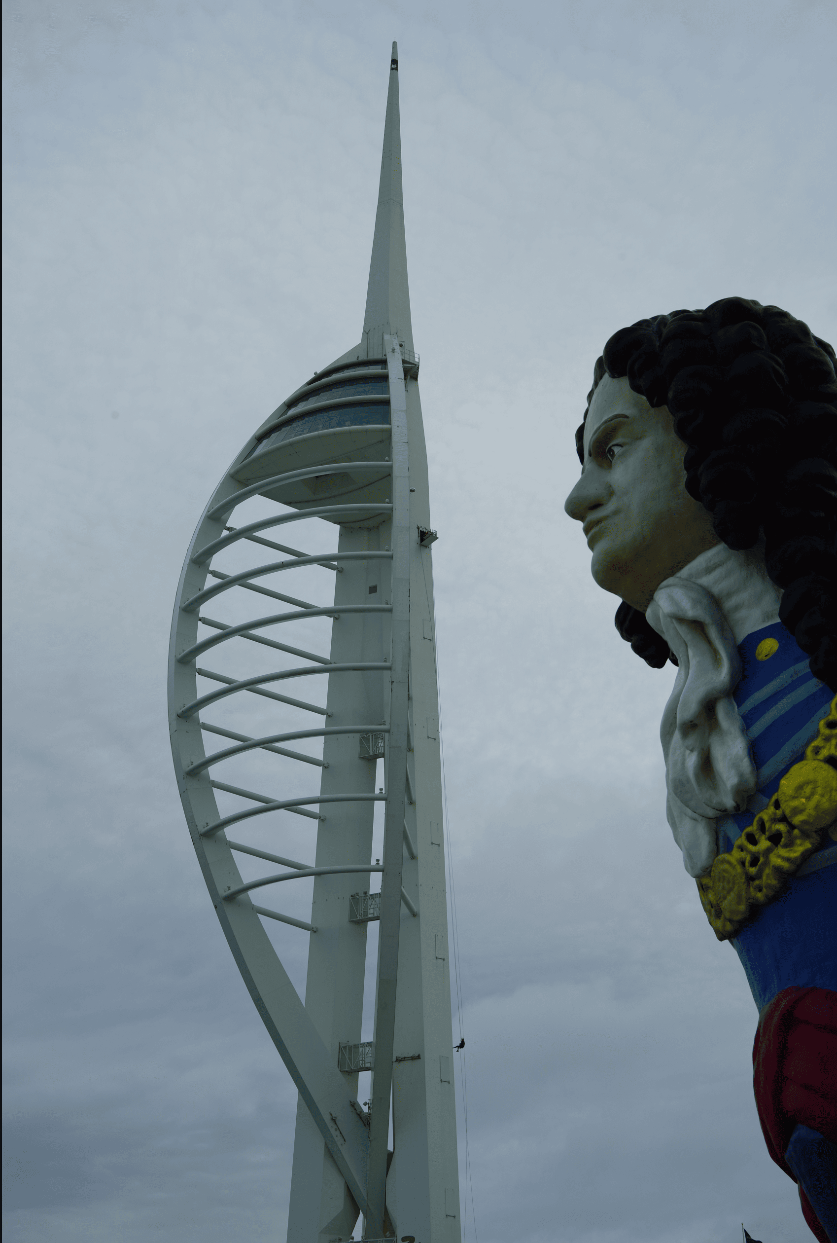 a ships figurehead on display outside with the Portsmouth spinnaker tower in the background
