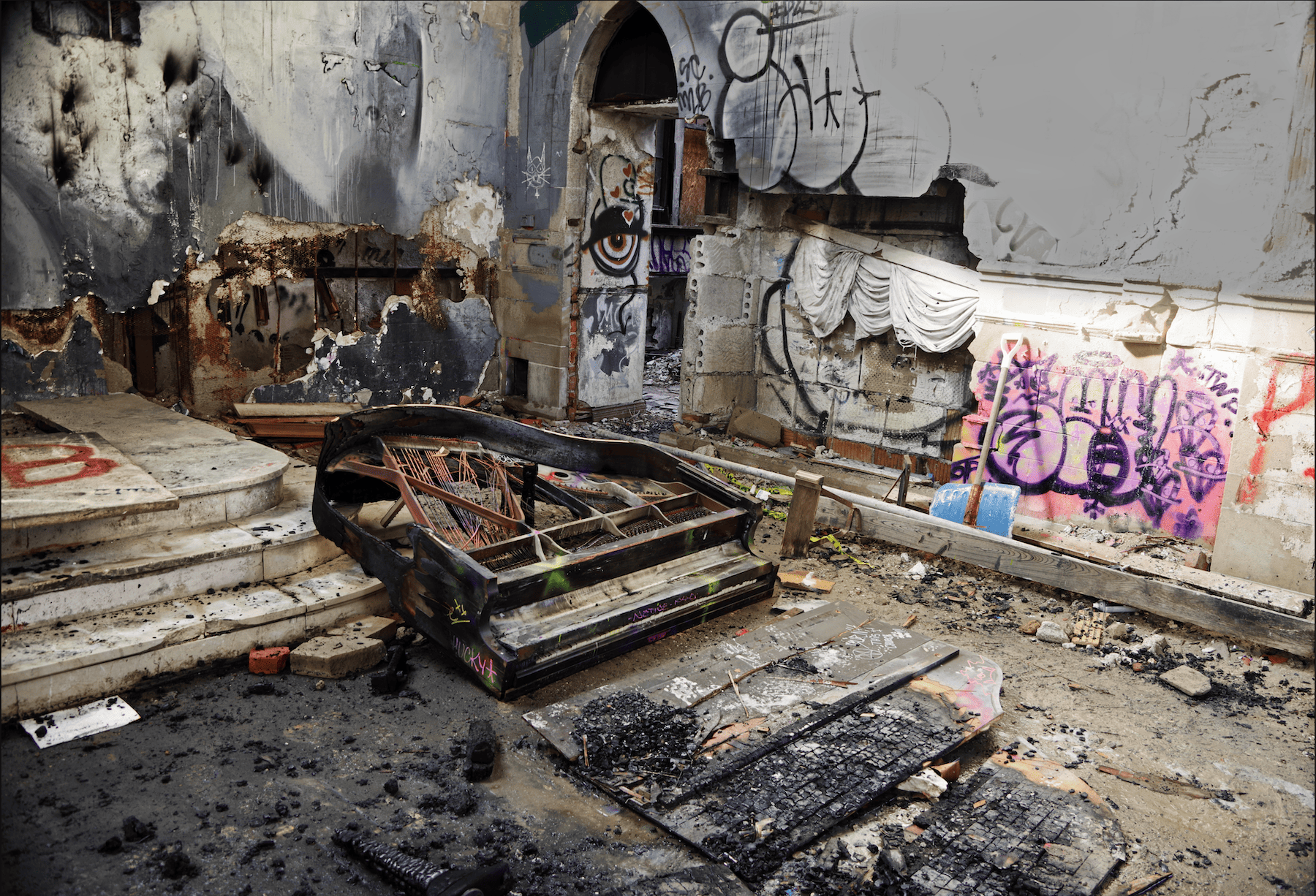 wrecked piano on the floor in an abandoned Detroit church